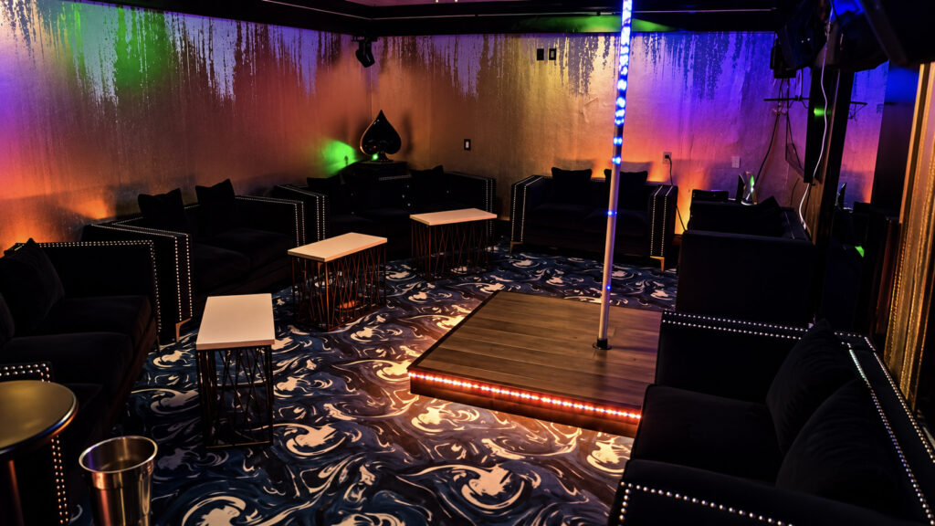 The Whale Room with lit dance pole, private stage and velvet seating at Rachel's North in Casselberry, Florida