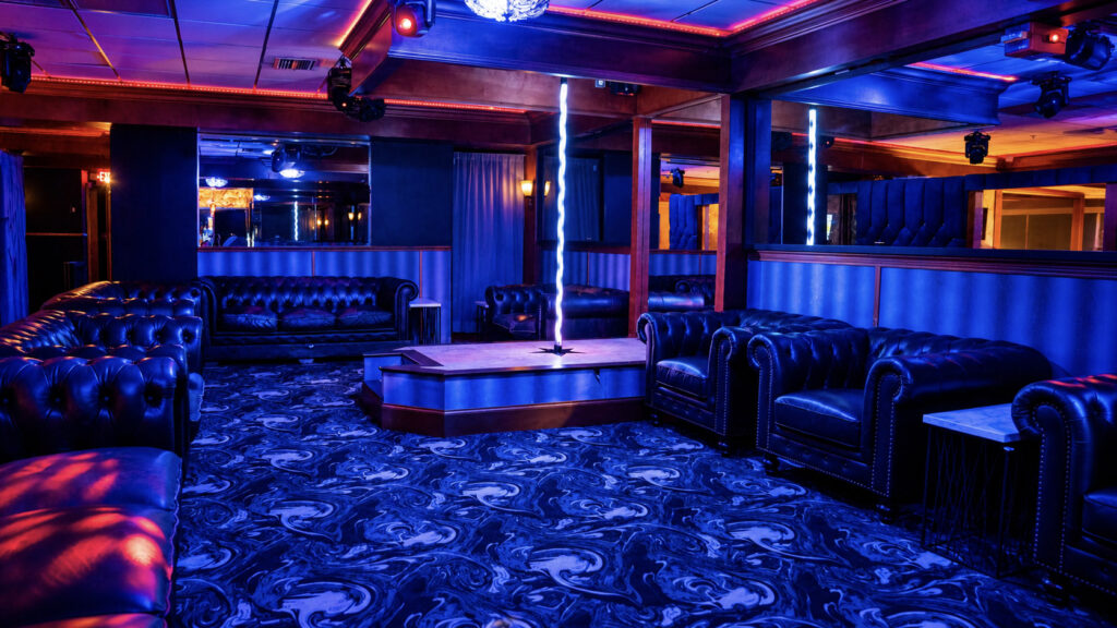 The upstairs private dance area with leather couches and a private stage at Rachel's North in Casselberry, Florida