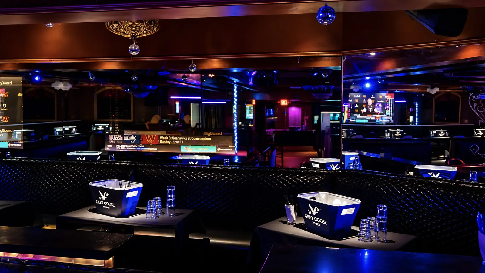 VIP tables set for bottle service on the main floor at Rachel's North in Casselberry, Florida, with lit ice buckets in tufted leather booths