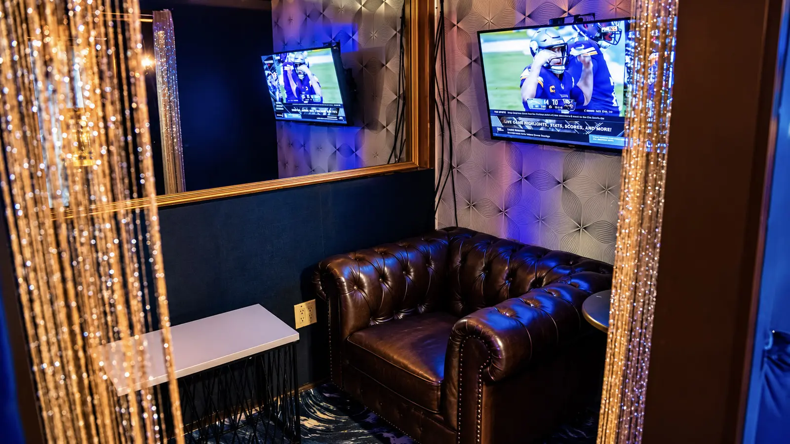 Inside a private VIP room upstairs at Rachel's North in Casselberry, with a leather Chesterfield chair, crystal bead curtain, tufted walls and private screens
