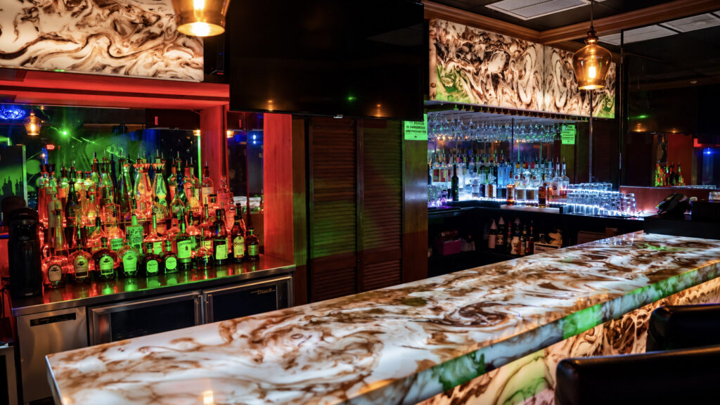 The VIP bar backbar lit in red and green at Rachel's North in Casselberry, Florida