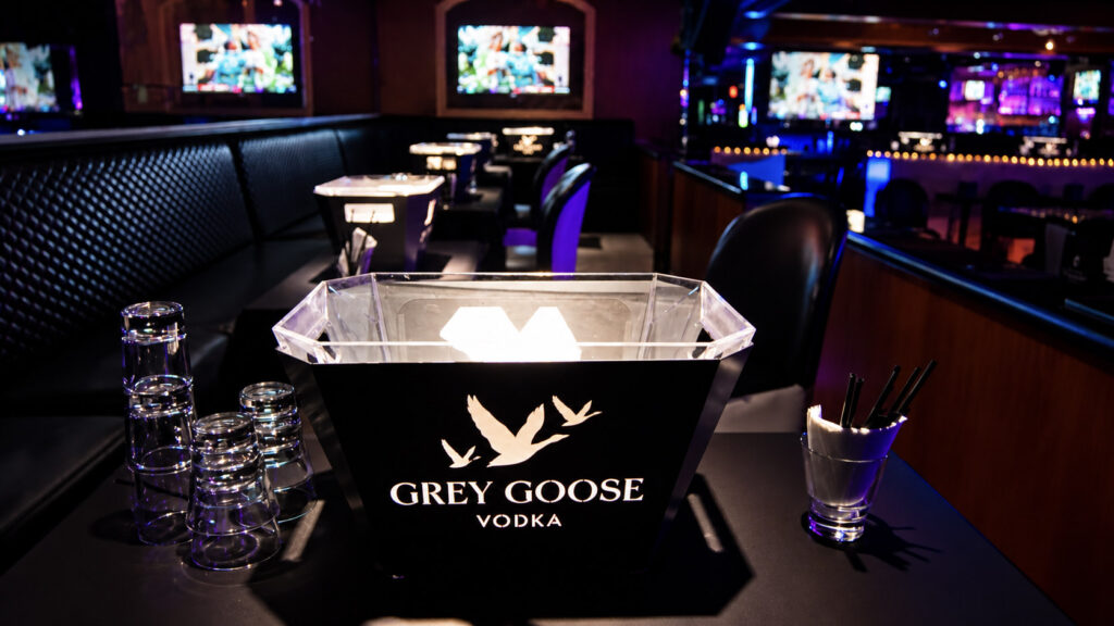 Main floor seating with bottle service tables and big screens at Rachel's North in Casselberry, Florida