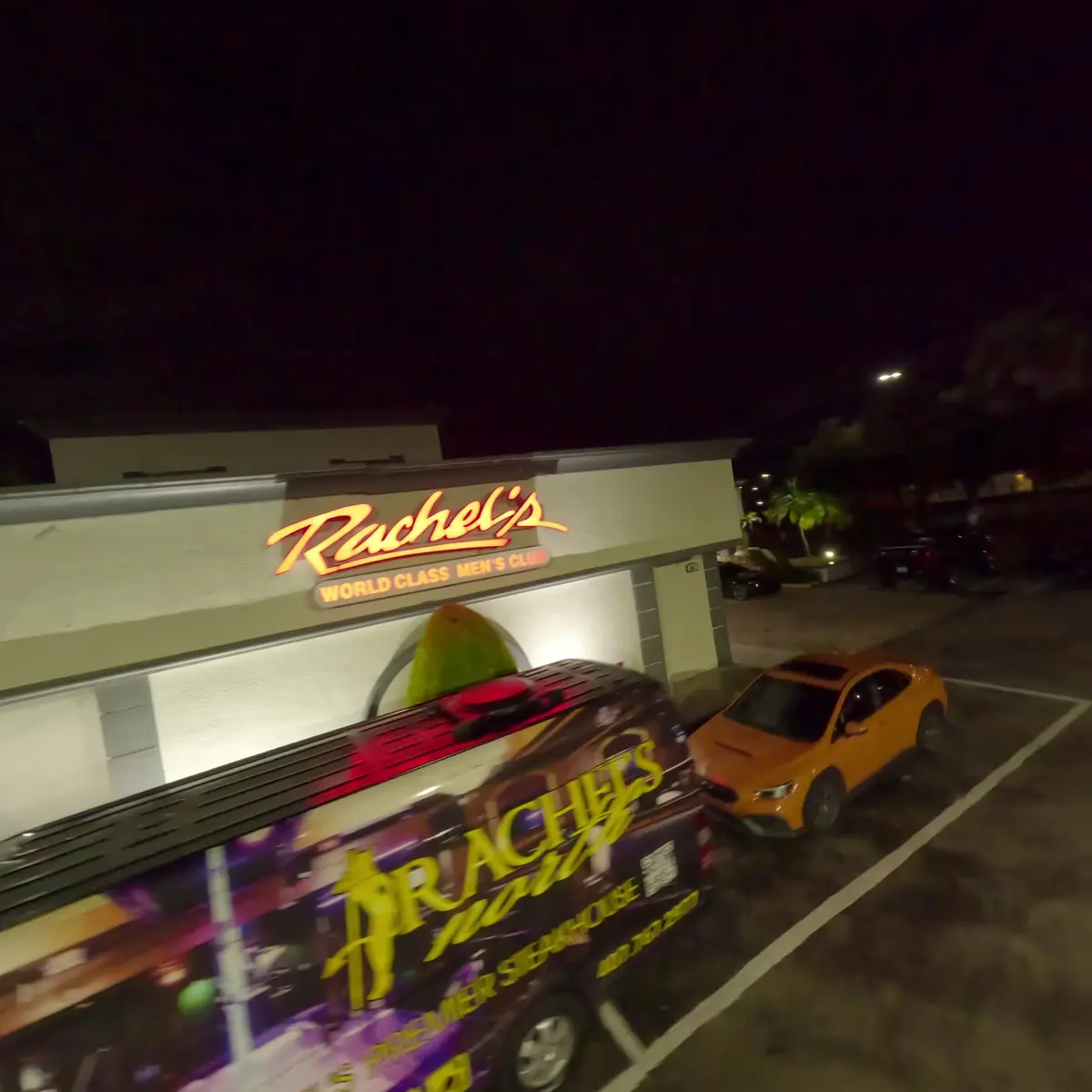 The lit Rachel&rsquo;s sign and the Rachel&rsquo;s North van outside the club at night on Semoran Boulevard in Casselberry, Florida
